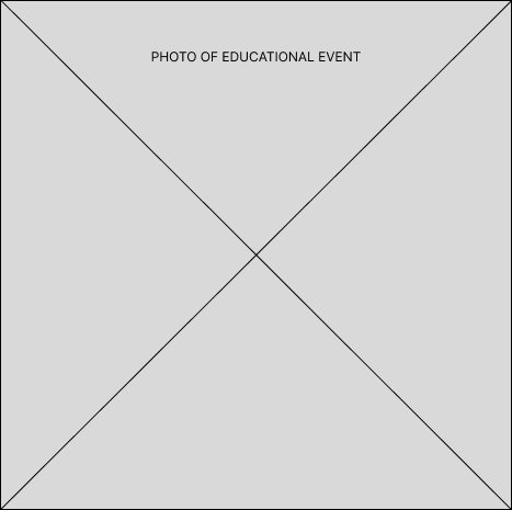 Photograph of students watching guest speaker talk